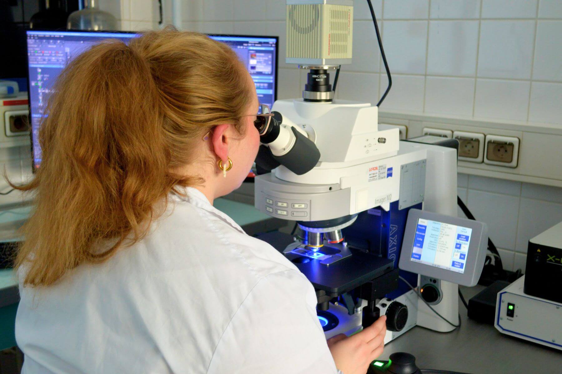 scientist working on bio Analyses with microscopy Immunoassay result