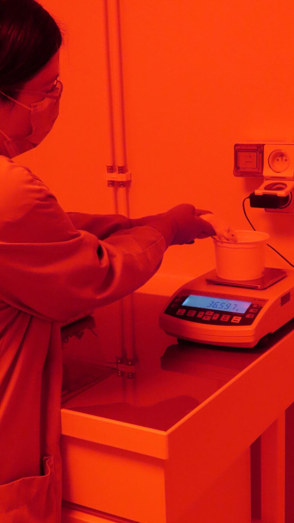 technician with animal at red-light lab